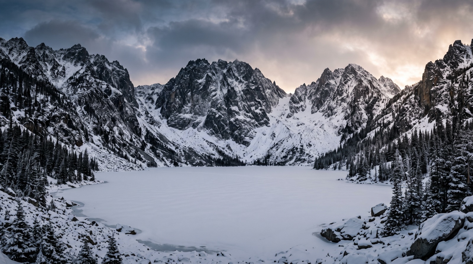 A high alpine lake ringed by granite peaks