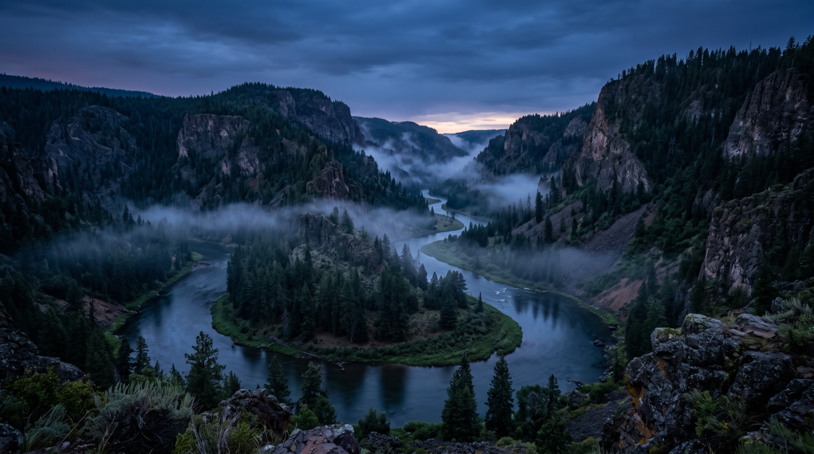 A misty tailwater river winding through a canyon