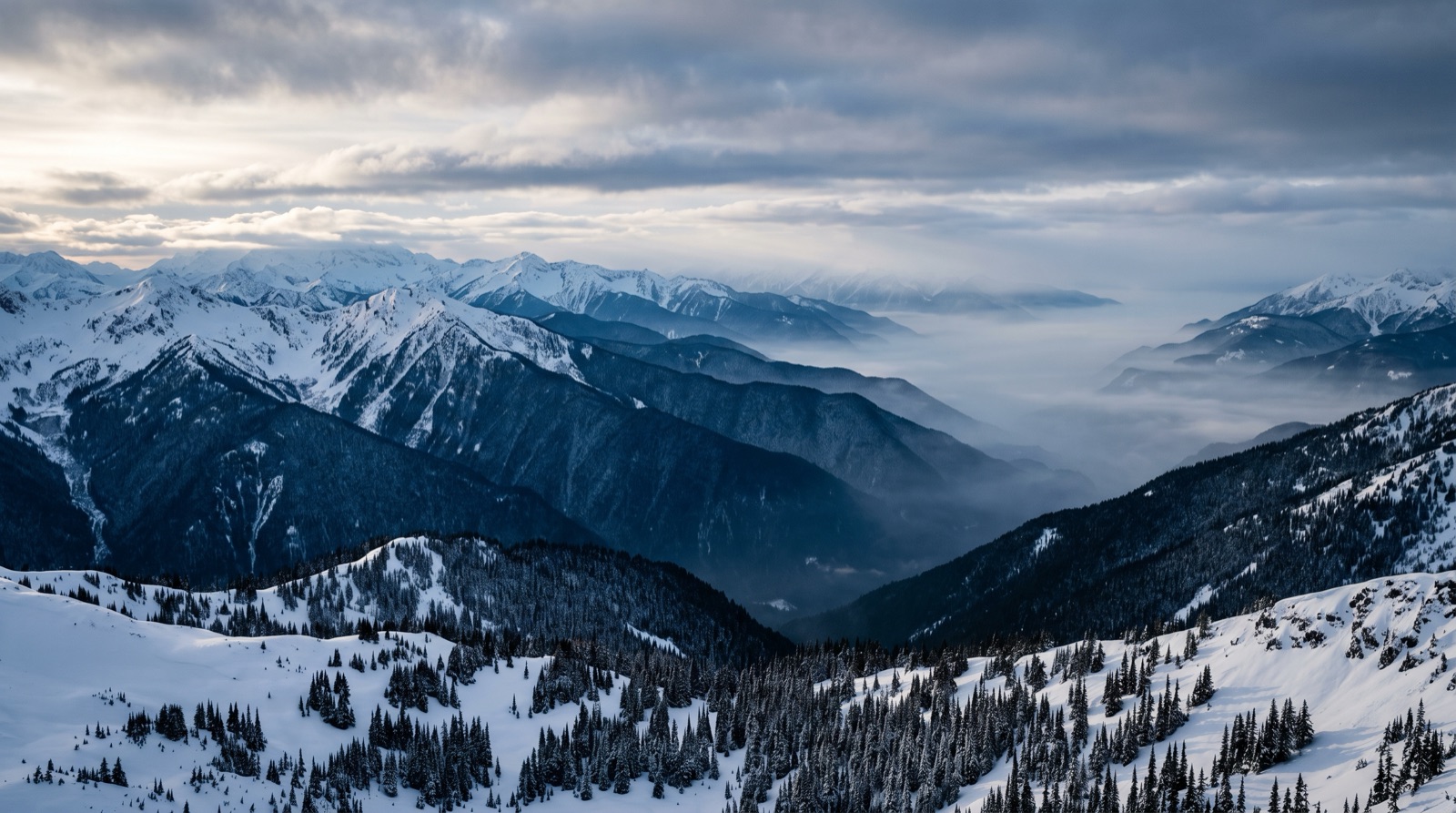 Layered blue mountain ridgelines in fog